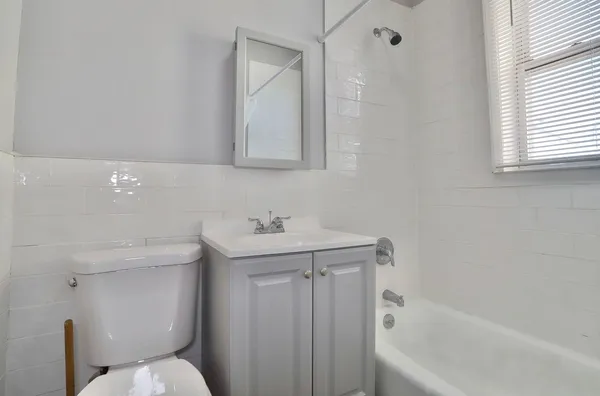a bathroom with a sink a toilet and bathtub
