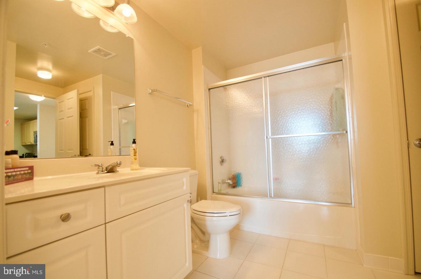 2726 Gallows Road, Unit 917 Vienna, VA 22180 - Photo 13 of 25 a bathroom with a double vanity sink toilet and shower