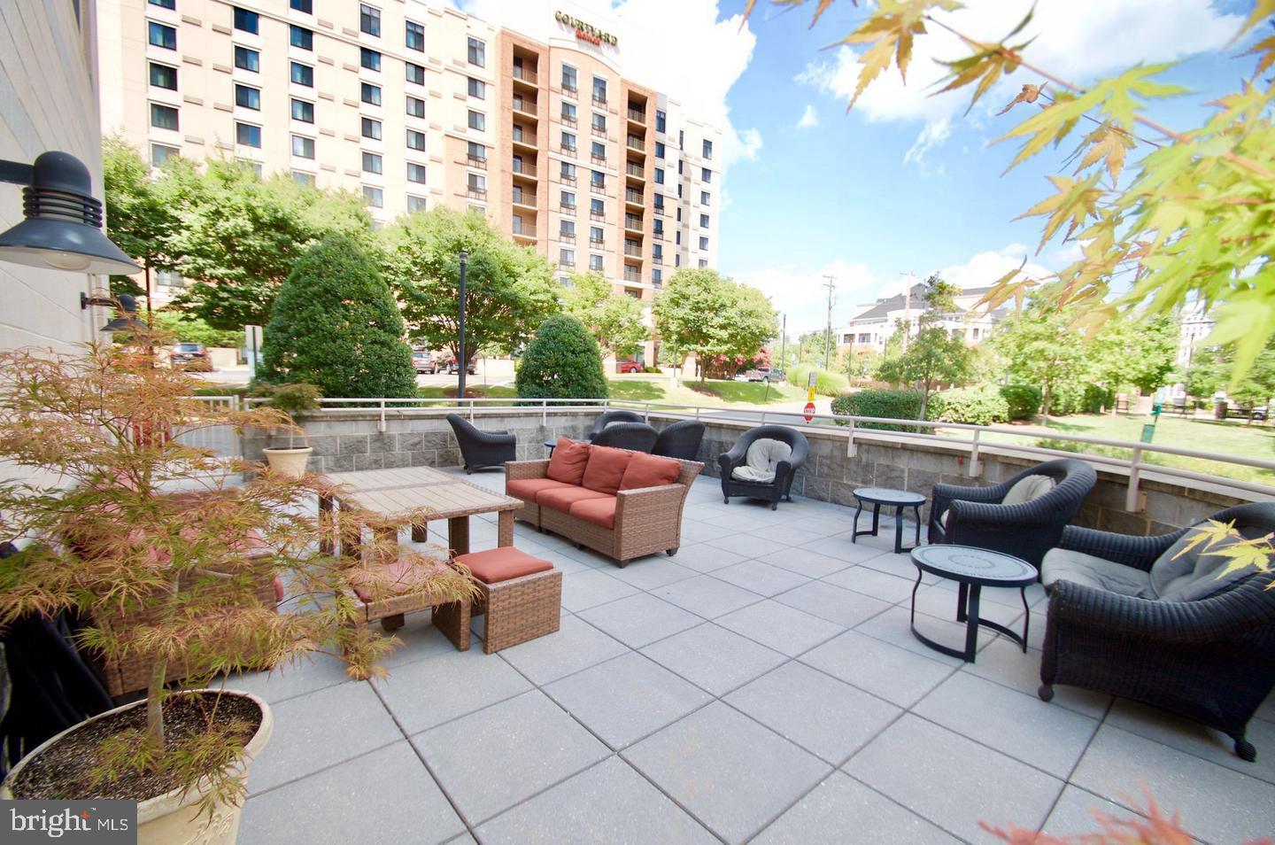 2726 Gallows Road, Unit 917 Vienna, VA 22180 - Photo 18 of 25 a balcony with couple of couches and potted plants