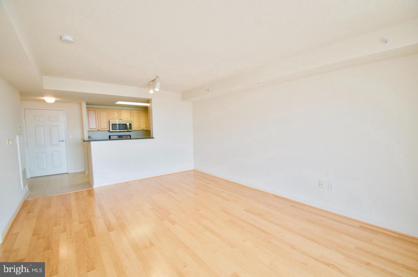2726 Gallows Road, Unit 917 Vienna, VA 22180 - Photo 3 of 25 a view of a big room with wooden floor and a window