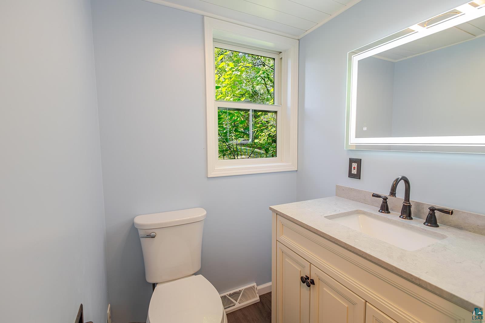 29 Ridge Road Esko, MN 55733 - Photo 17 of 41 Bathroom vanity with an integrated sink, light-toned countertop, and dark-toned faucet hardware
