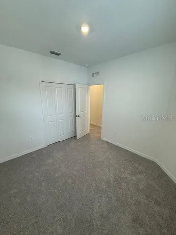 a view of kitchen with stainless steel appliances refrigerator stove microwave and cabinets