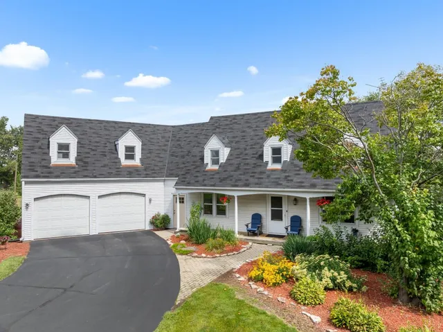 a front view of house with yard and outdoor seating