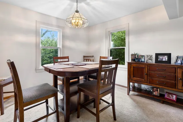 a living room with furniture a flat screen tv and kitchen view