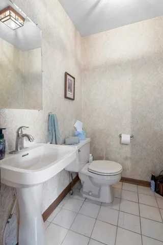 a bedroom with a bed a couch and dresser