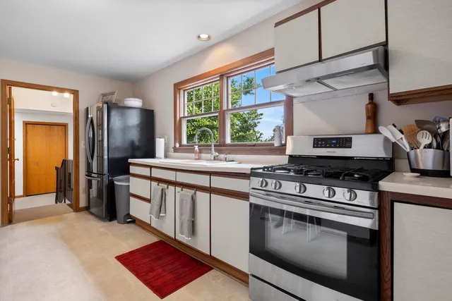 a kitchen with stainless steel appliances kitchen island granite countertop a sink and cabinets