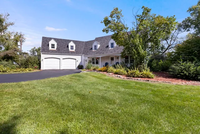 a backyard of a house with a yard and outdoor seating
