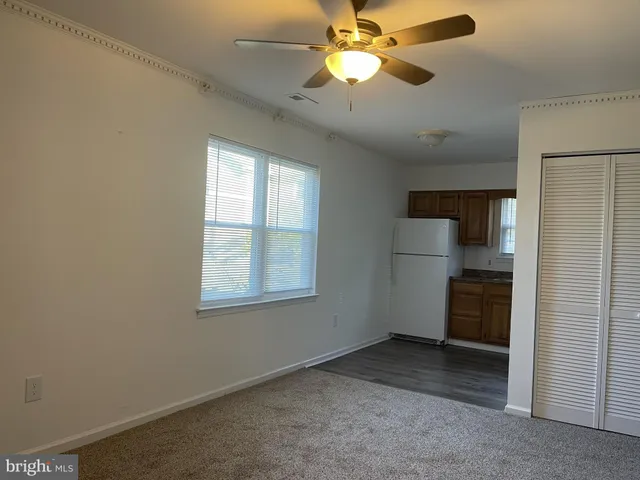 an empty room with closet and windows