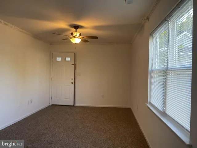a view of a chandelier fan and wooden floor