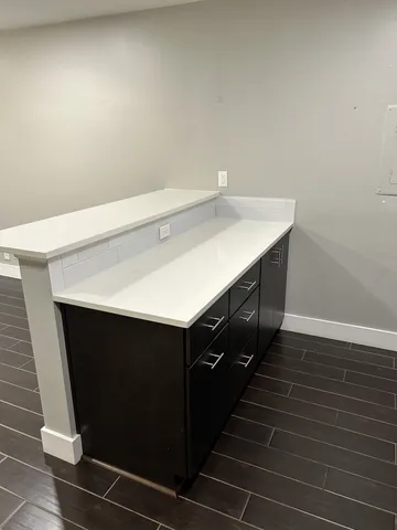 a kitchen with a sink and cabinets