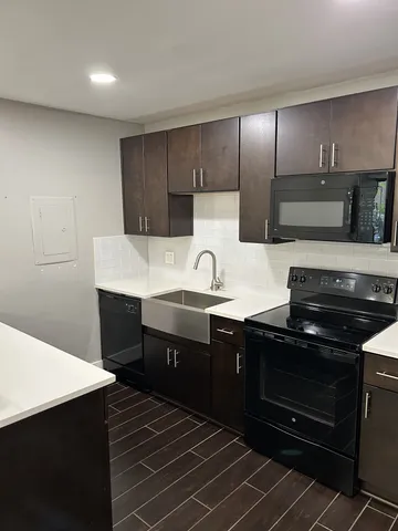 a kitchen with a sink and cabinets