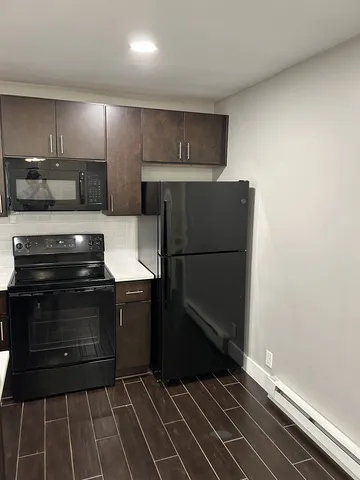 a kitchen with a refrigerator and a stove