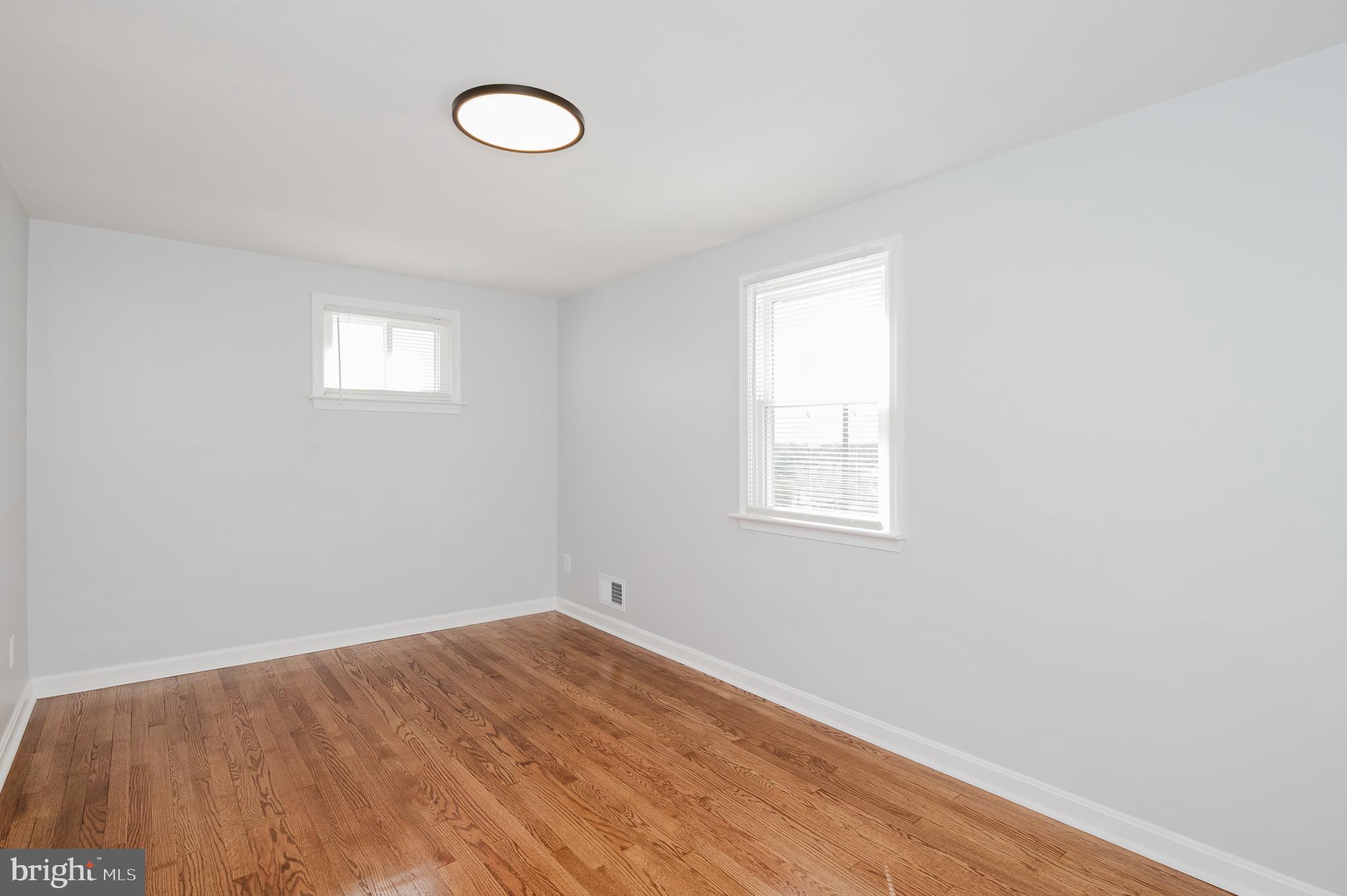 8029 Neighbors Avenue Rosedale, MD 21237 - Photo 25 of 42 PRIMARY BEDROOM/ REFINISHED HARDWOOD FLOOR