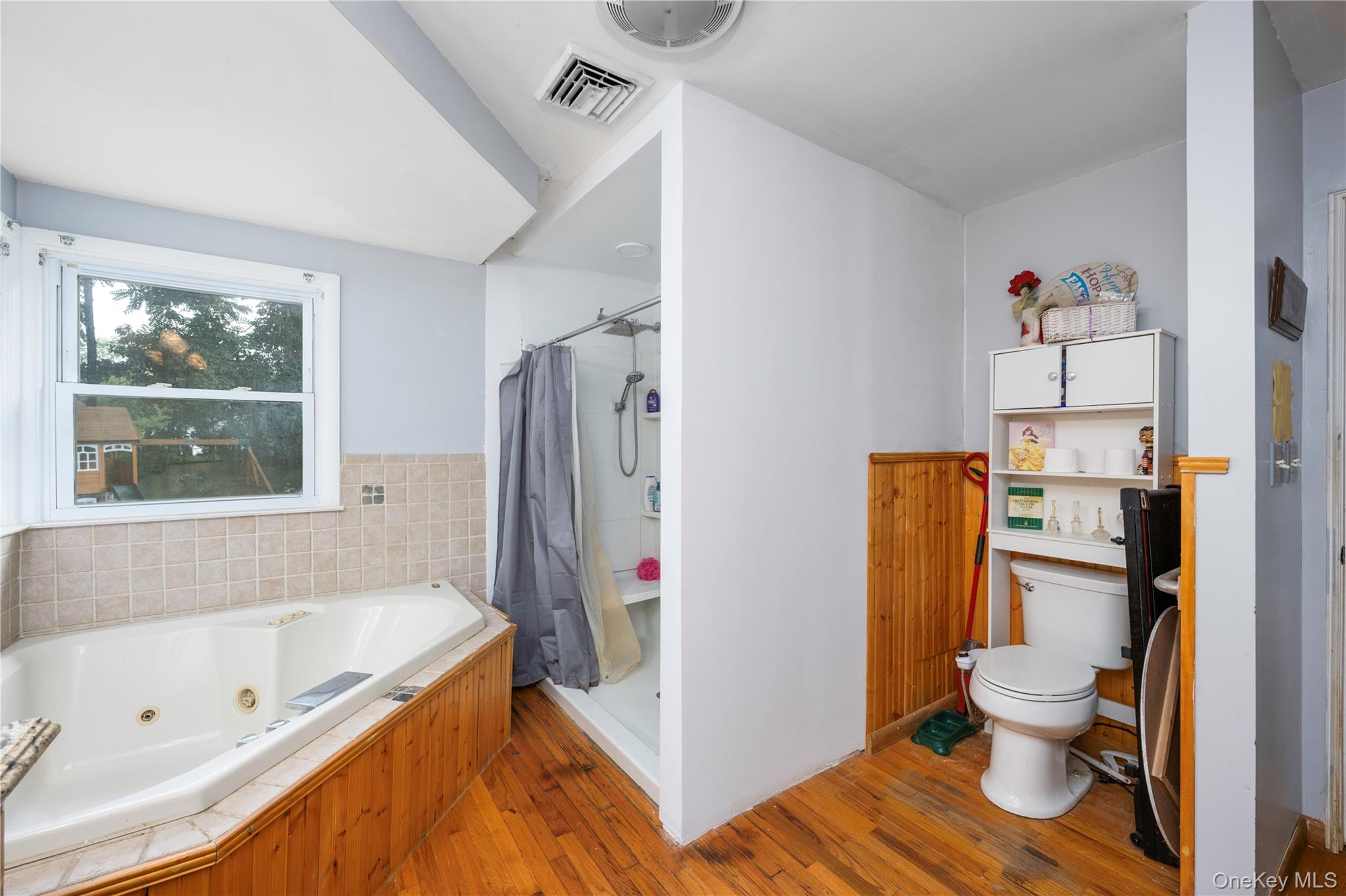 1 Essex Road Poughkeepsie, NY 12601 - Photo 11 of 21 Full bath with light wood-style floors, a stall shower, and a jetted tub