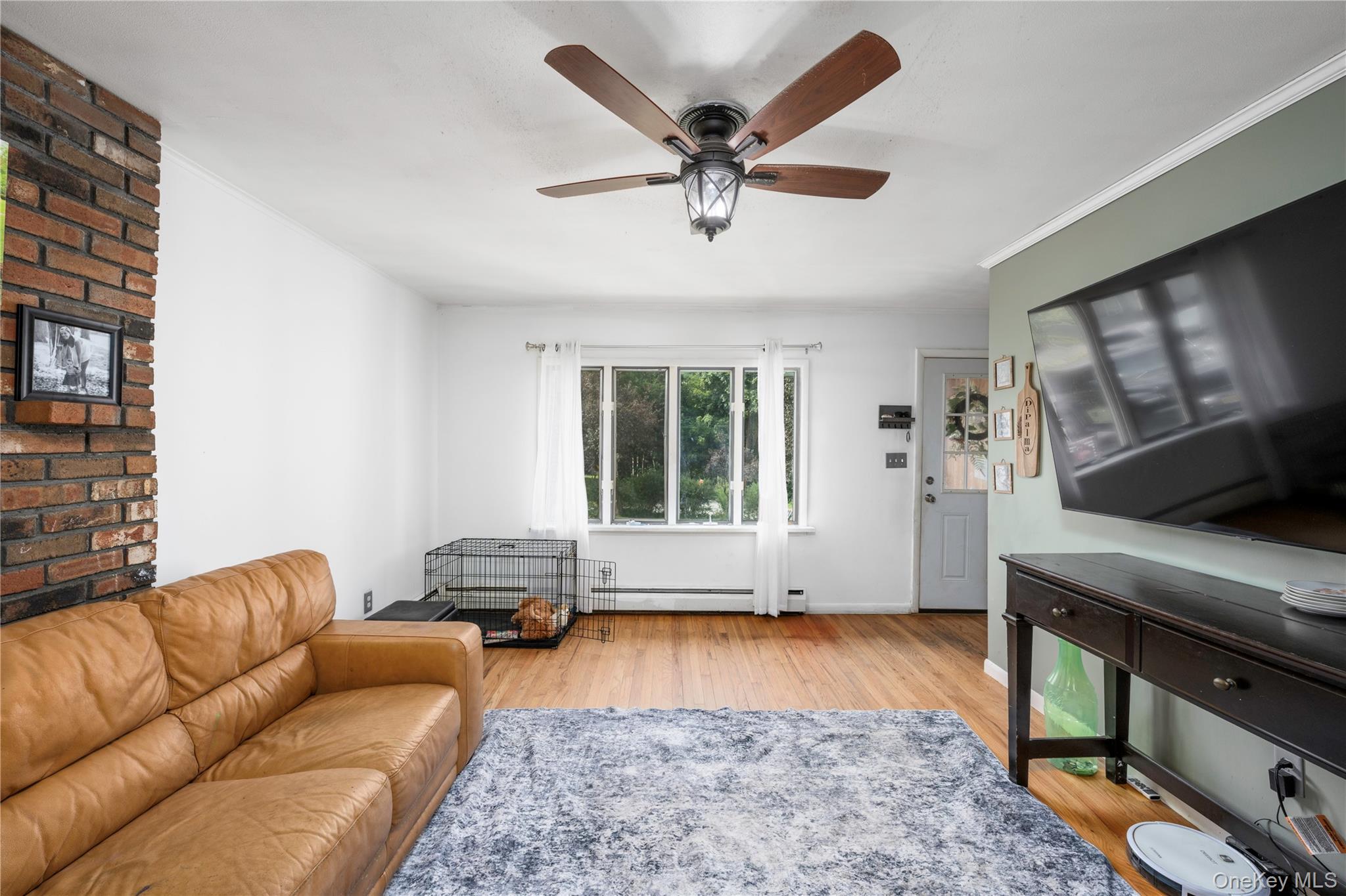 1 Essex Road Poughkeepsie, NY 12601 - Photo 3 of 21 Living room with hardwood floors and partial brick wall.