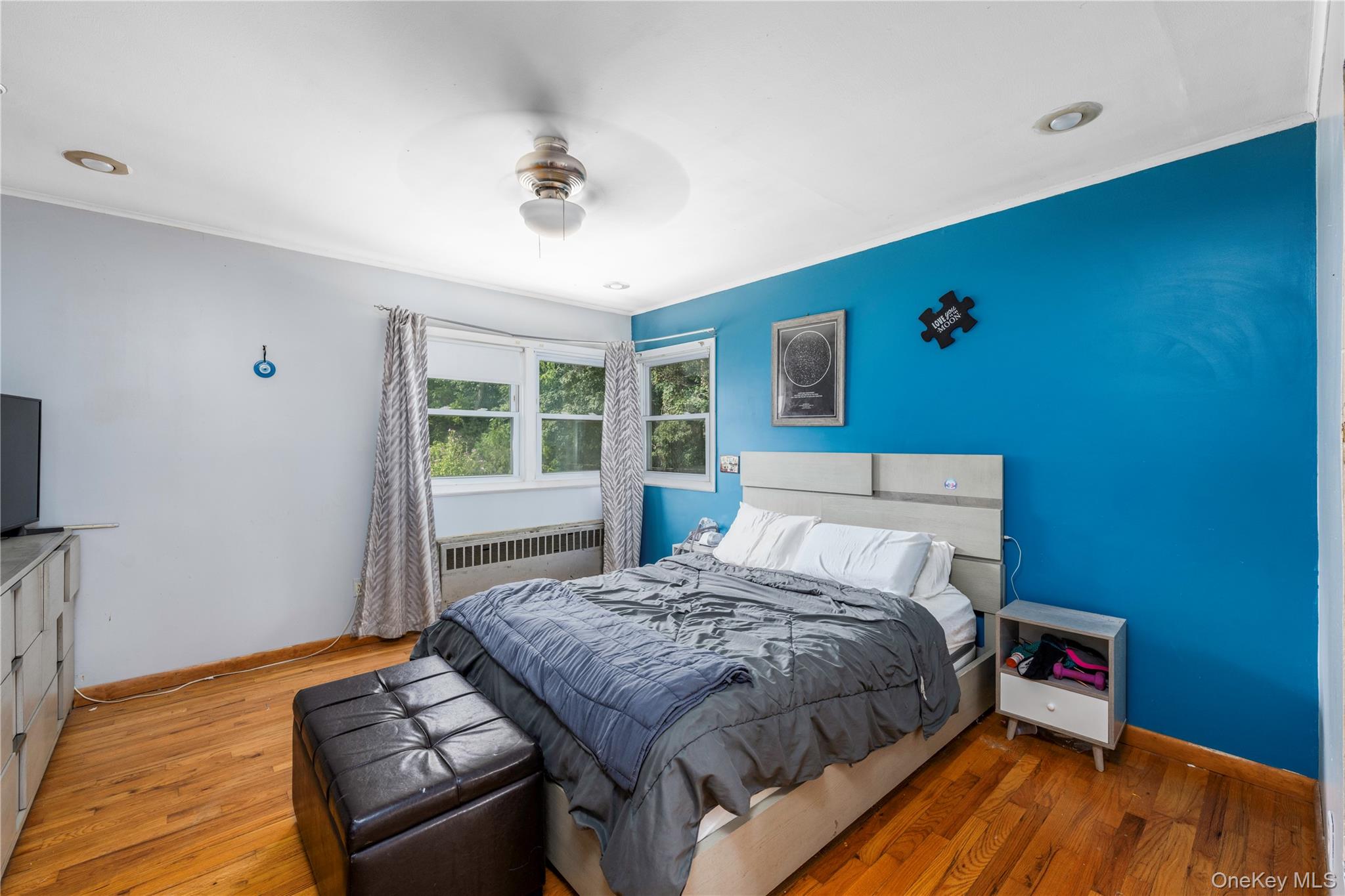 1 Essex Road Poughkeepsie, NY 12601 - Photo 8 of 21 Bedroom featuring wood finished floors, radiator, ceiling fan, and crown molding