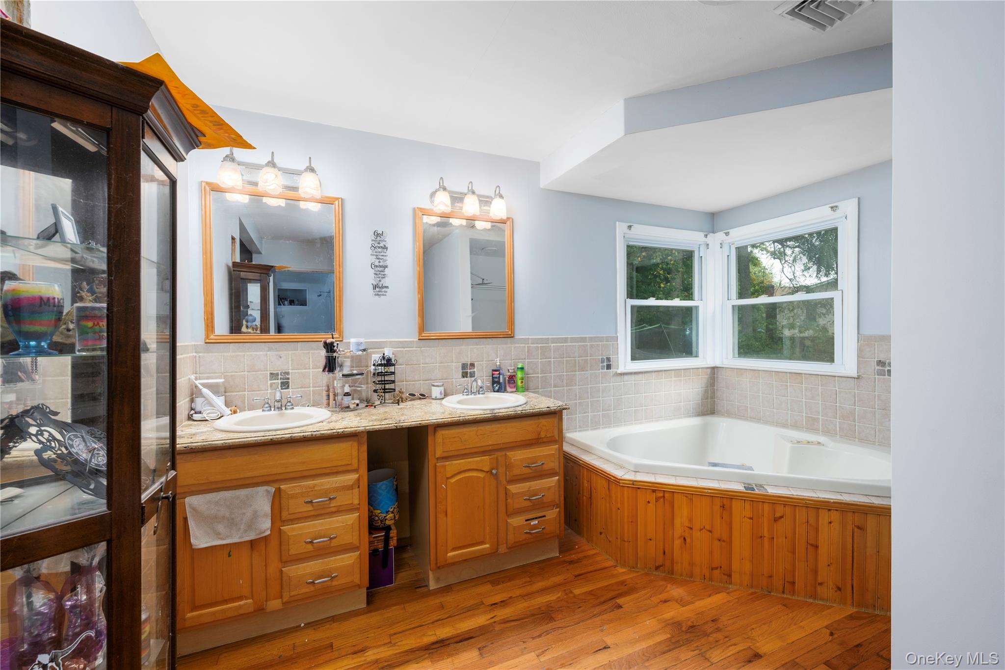 1 Essex Road Poughkeepsie, NY 12601 - Photo 10 of 21 Bathroom with double vanity, a bath, and light wood finished floors