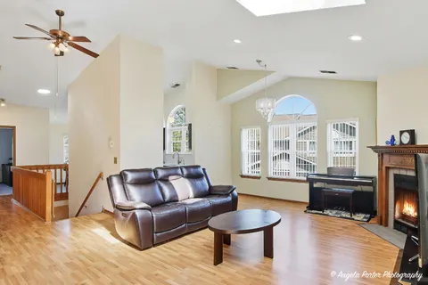a living room with furniture a fireplace and a flat screen tv