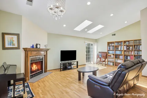 a living room with a book shelf and a book shelf