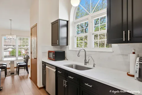 a kitchen with a sink a counter top space and stainless steel appliances