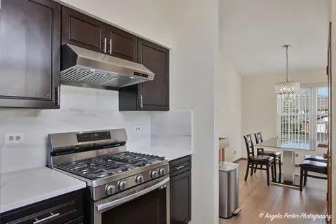 a kitchen with stainless steel appliances a sink a stove and a refrigerator