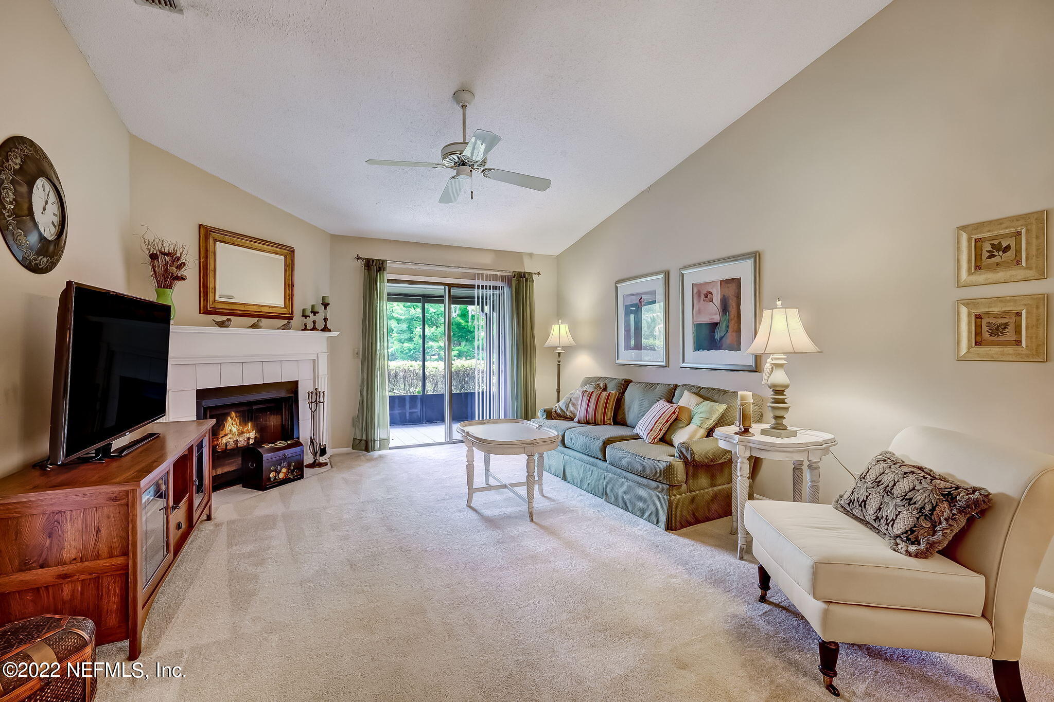 3801 Crown Point Road, Unit 1265 Jacksonville, FL 32257 - Photo 2 of 8 a living room with furniture a fireplace and a flat screen tv
