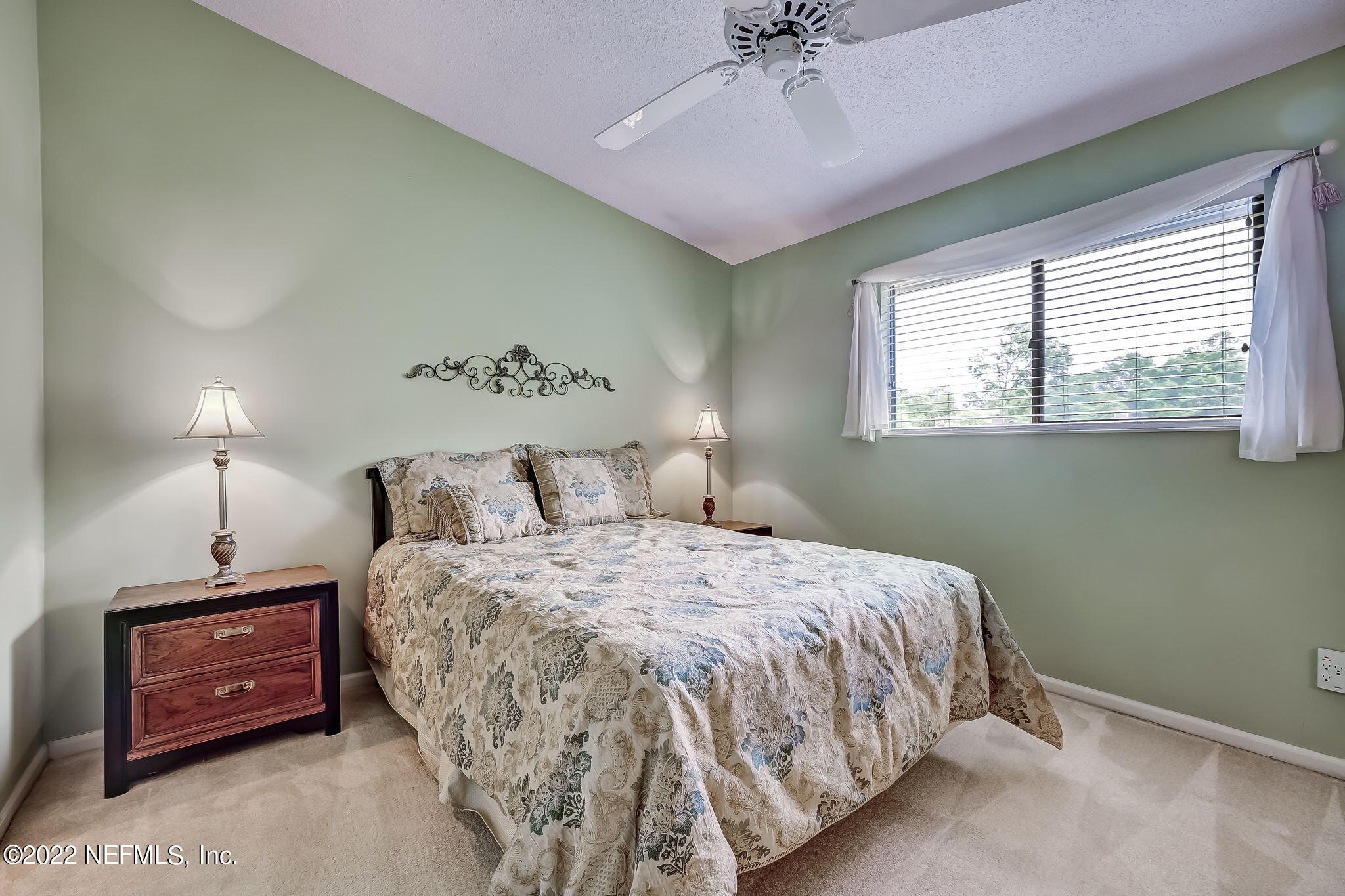 3801 Crown Point Road, Unit 1265 Jacksonville, FL 32257 - Photo 6 of 8 a bedroom with a bed and a chandelier