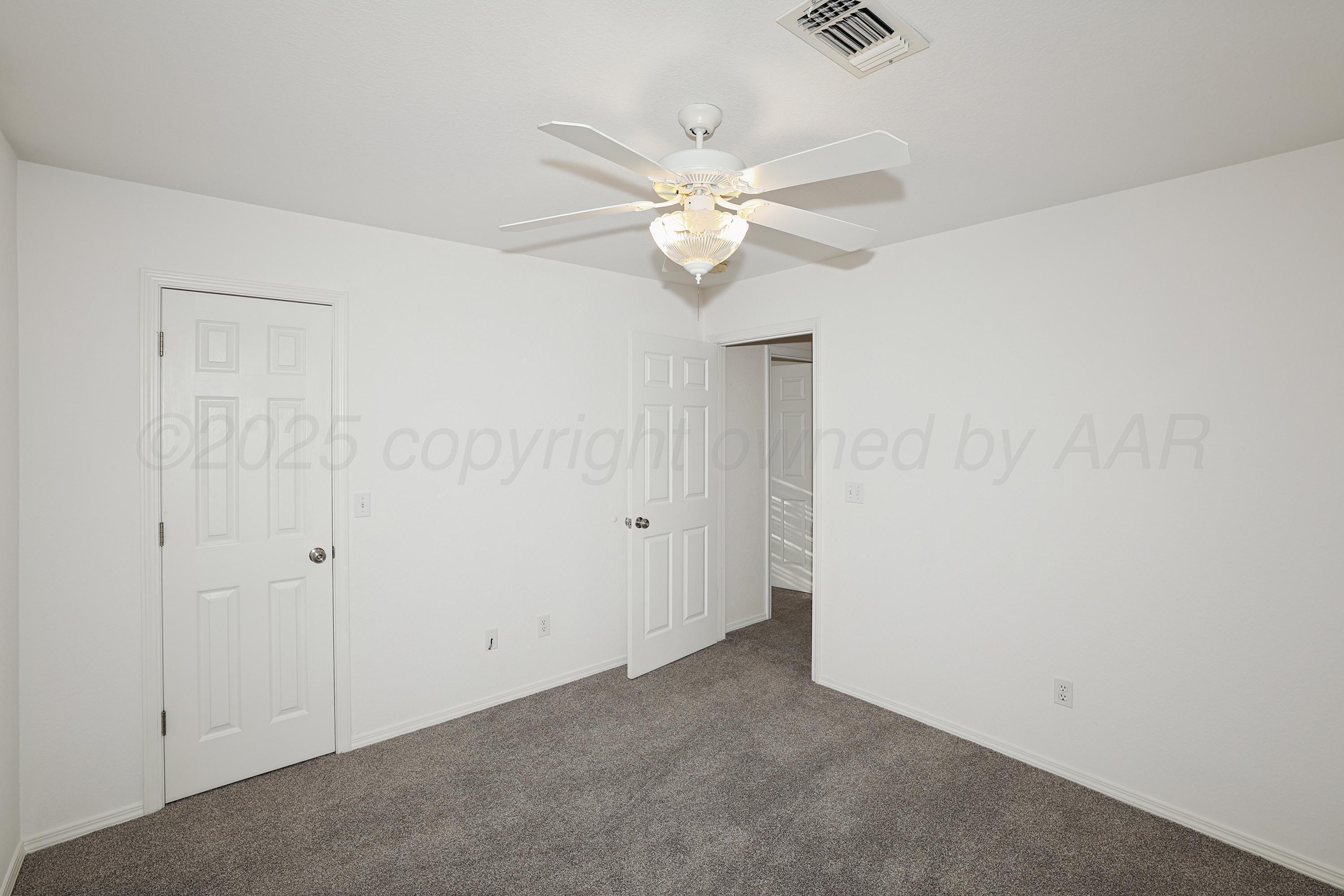 6212 Oakcrest Lane Amarillo, TX 79109 - Photo 16 of 33 an empty room with a window and a fan