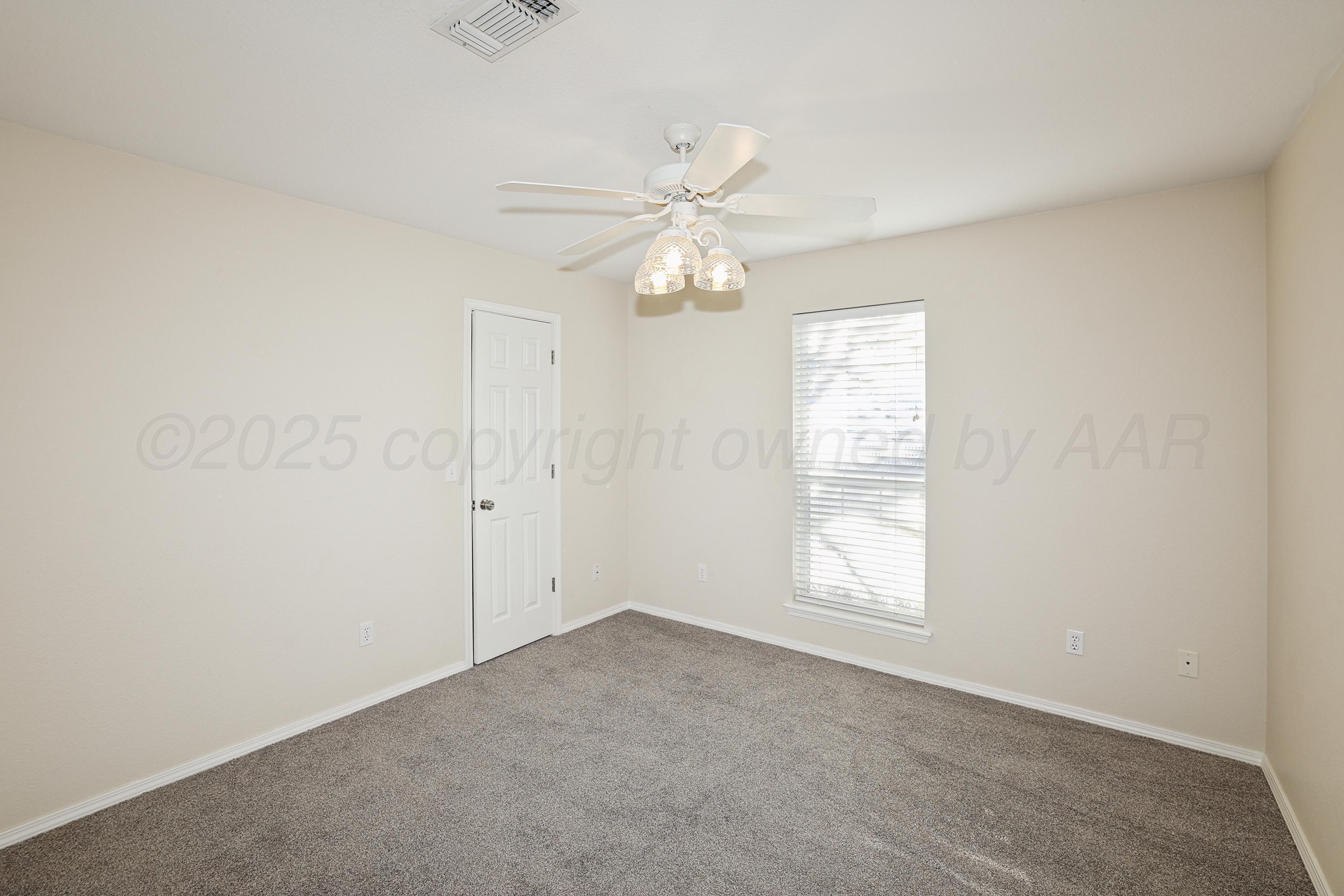 6212 Oakcrest Lane Amarillo, TX 79109 - Photo 18 of 33 an empty room with windows and fan