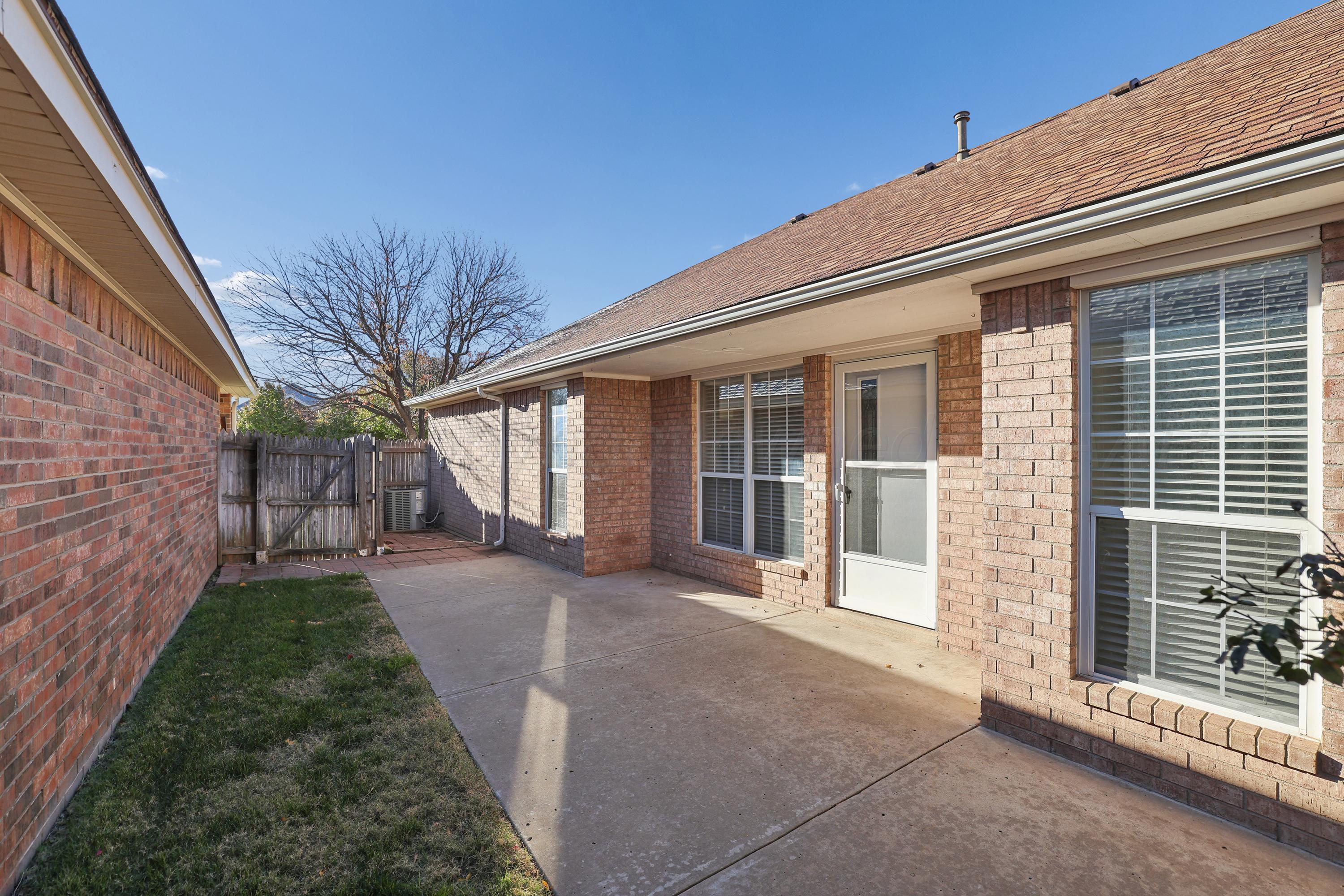 6212 Oakcrest Lane Amarillo, TX 79109 - Photo 23 of 33 a view of a house with a yard