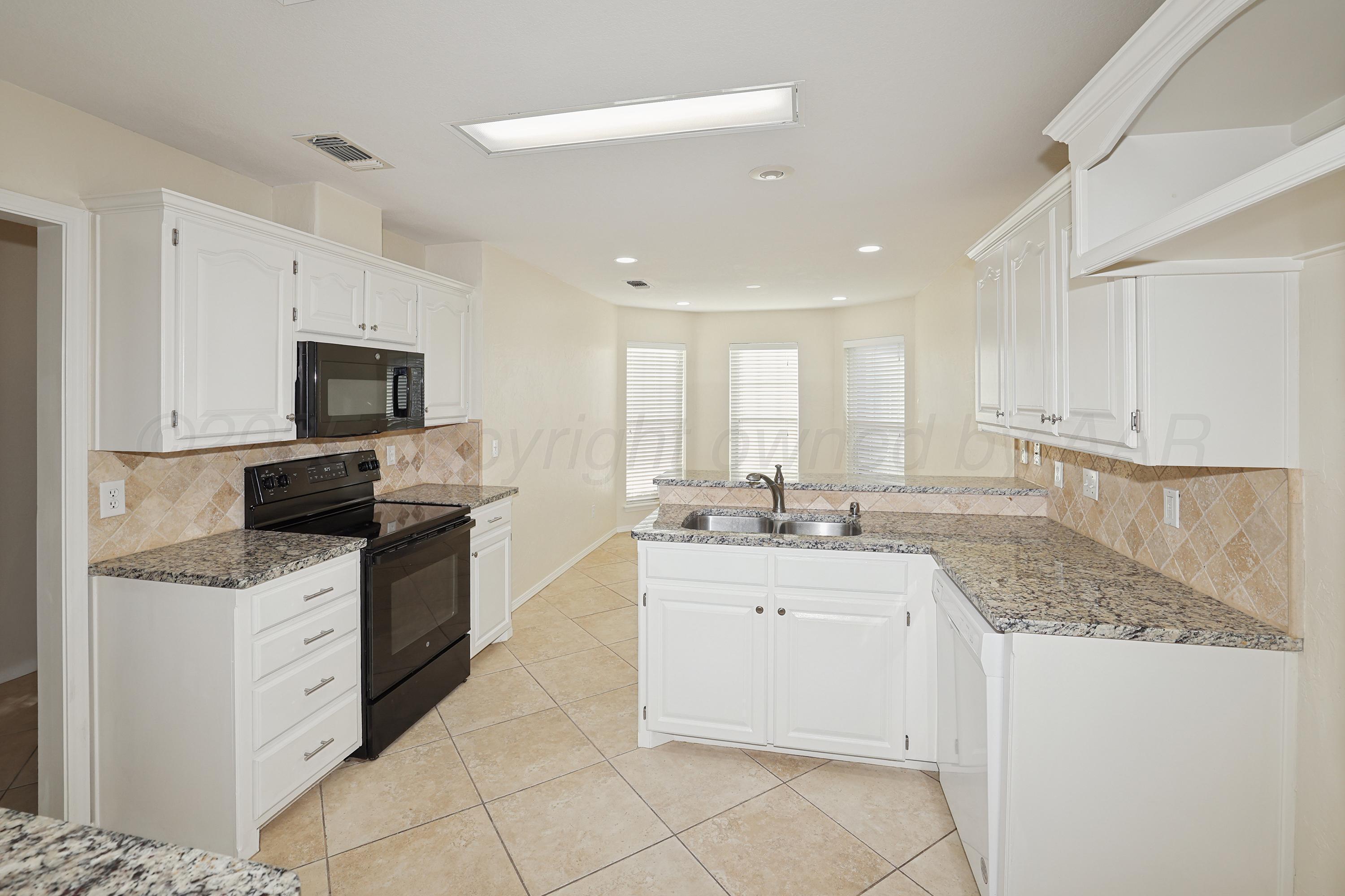 6212 Oakcrest Lane Amarillo, TX 79109 - Photo 3 of 33 a kitchen with a sink stove and microwave