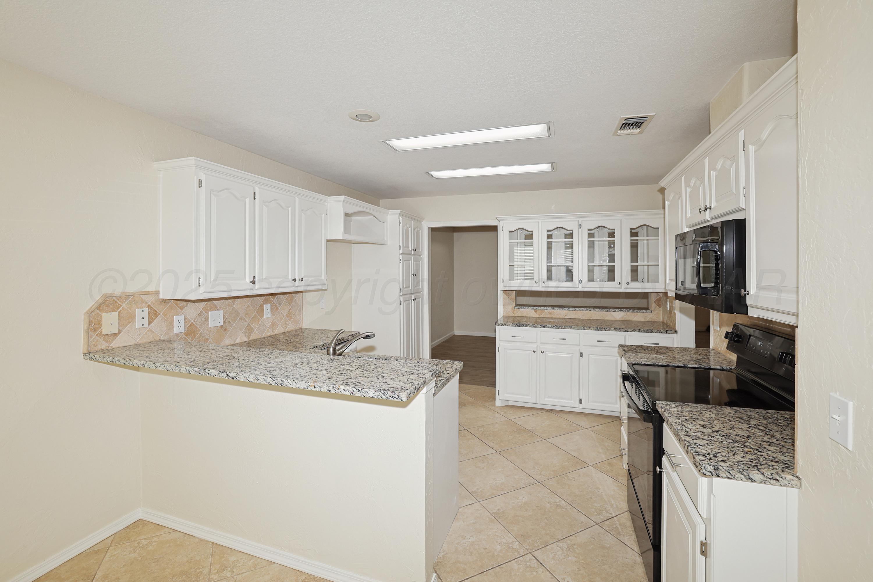 6212 Oakcrest Lane Amarillo, TX 79109 - Photo 4 of 33 a kitchen with a sink stove and cabinets