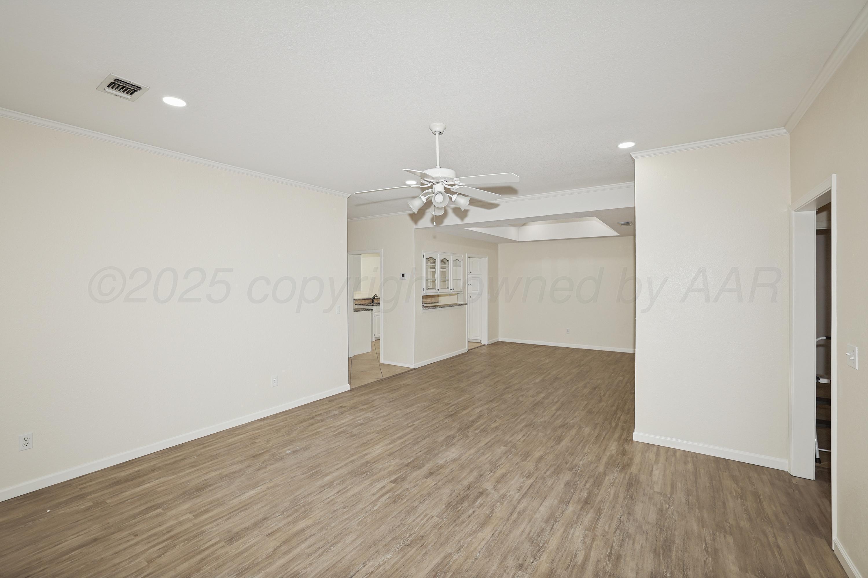 6212 Oakcrest Lane Amarillo, TX 79109 - Photo 5 of 33 wooden floor in an empty room with a window