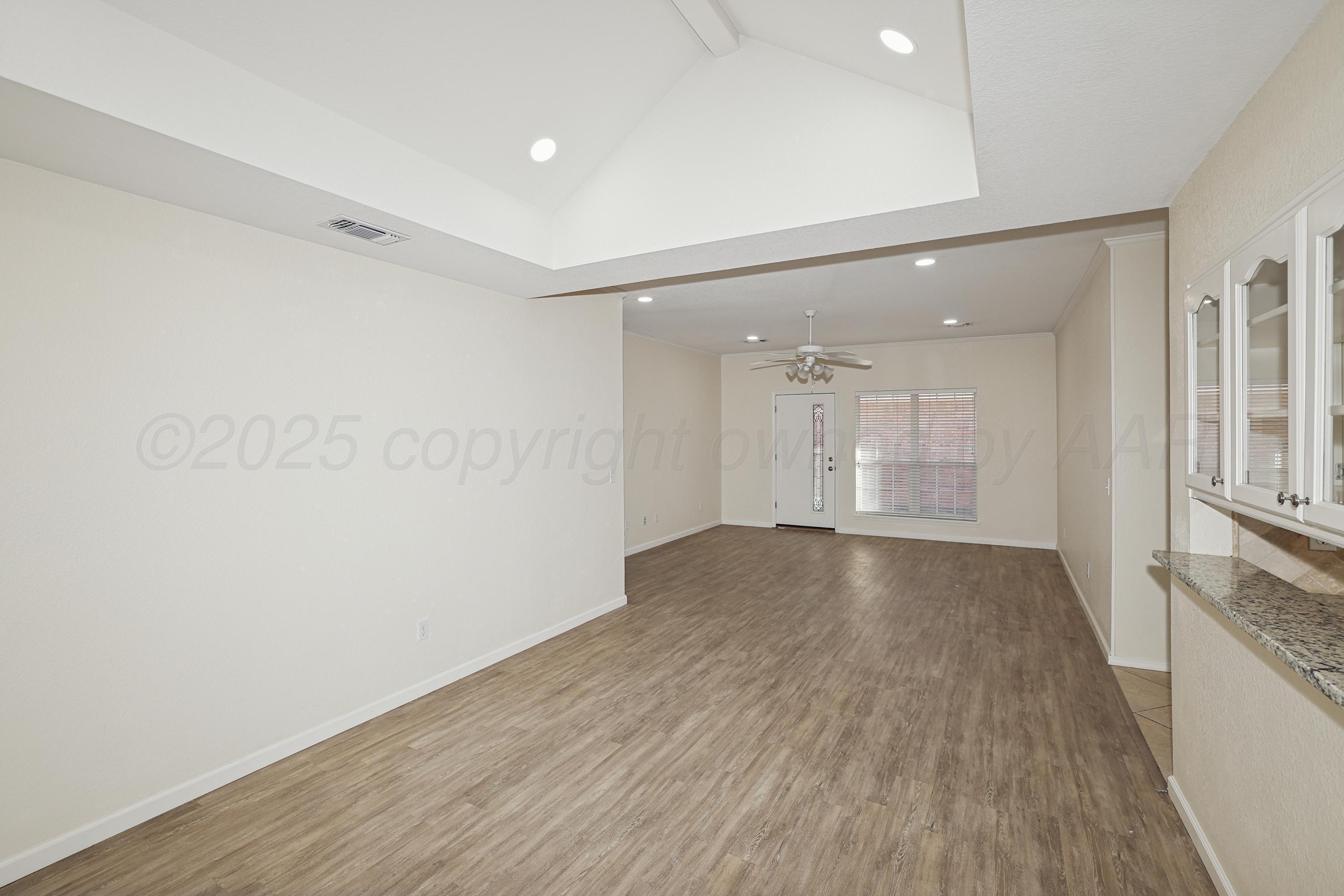 6212 Oakcrest Lane Amarillo, TX 79109 - Photo 7 of 33 a view of empty room with wooden floor and fan