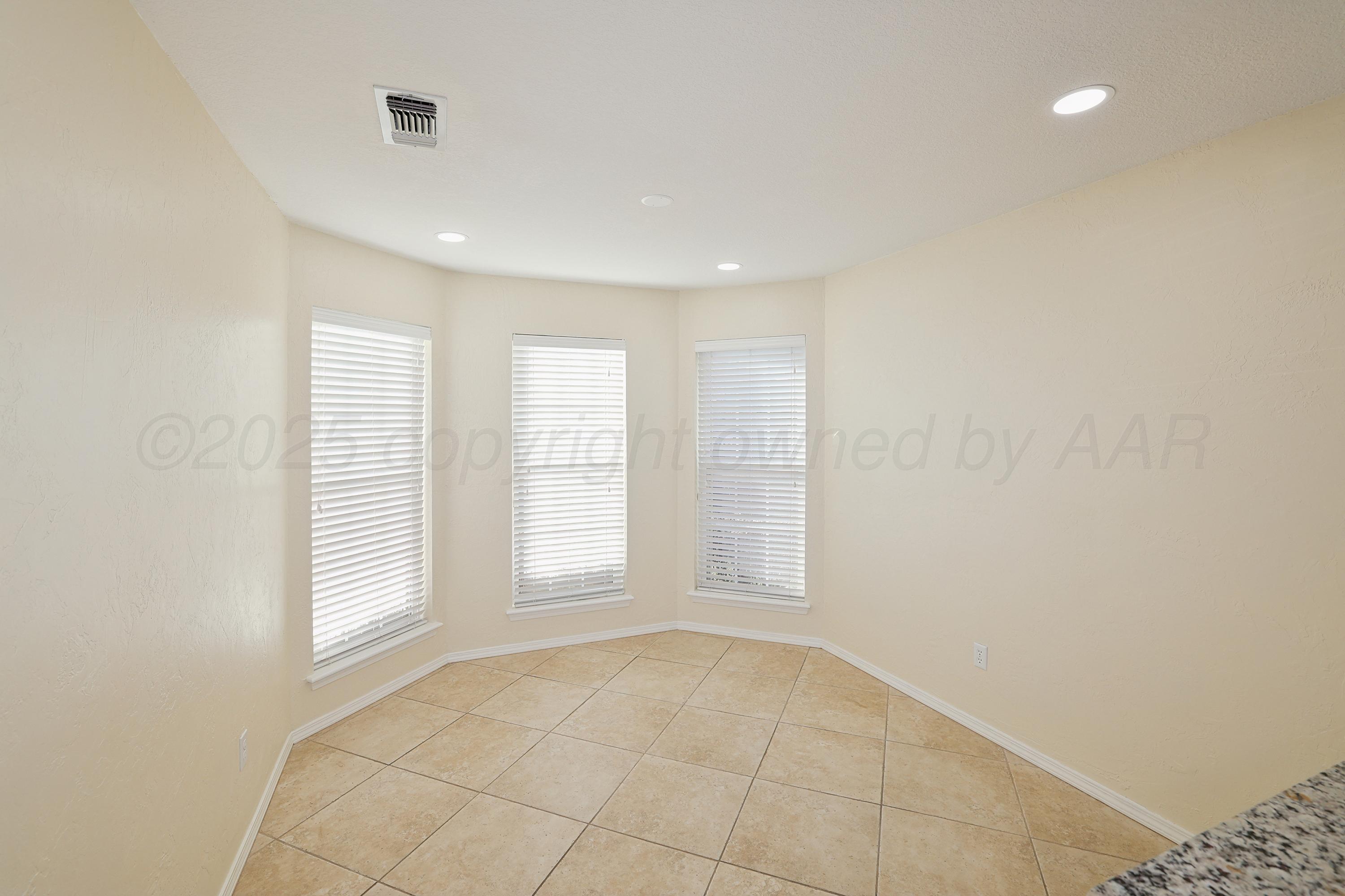 6212 Oakcrest Lane Amarillo, TX 79109 - Photo 9 of 33 an empty room with windows