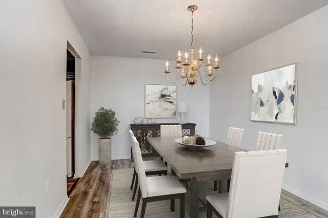 a view of a dining room with furniture and chandelier