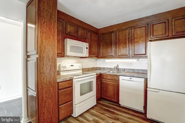 a kitchen with stainless steel appliances granite countertop a refrigerator and cabinets