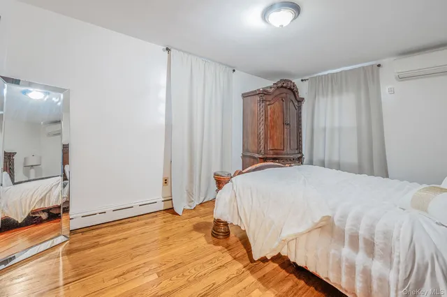 a bedroom with a bed and a mirror