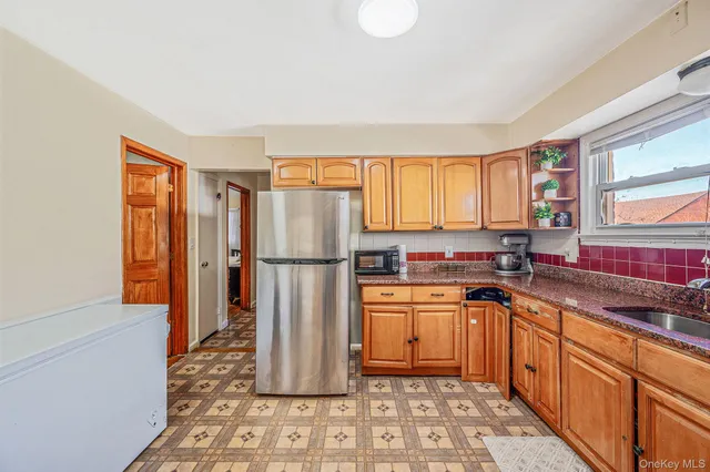 a kitchen with stainless steel appliances granite countertop a refrigerator and a sink