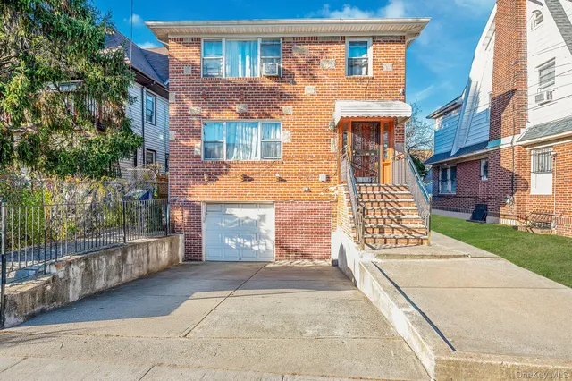 front view of a brick house with a large windows