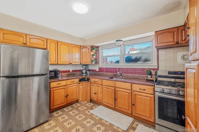 a kitchen with stainless steel appliances granite countertop a refrigerator sink and stove