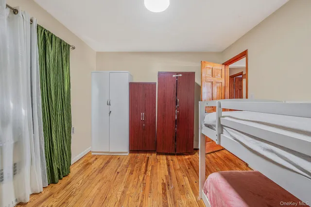 a hallway with a large window and wooden floor