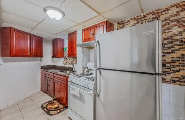 a kitchen with stainless steel appliances granite countertop a refrigerator and a stove