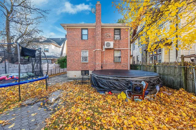 a wooden bench sitting in front of a building