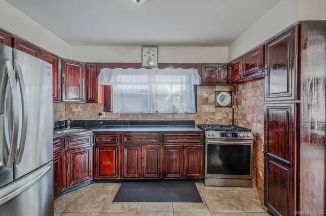 a kitchen with stainless steel appliances granite countertop a stove sink and refrigerator
