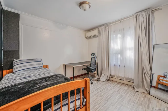 a bedroom with bed and wooden floor