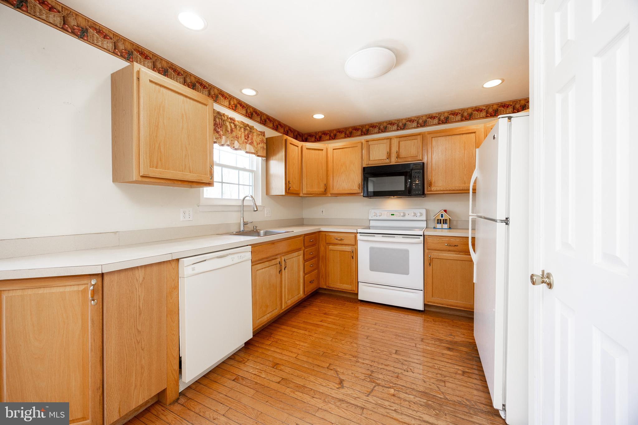222 Springvalley Way Aston, PA 19014 - Photo 11 of 45 a kitchen with stainless steel appliances granite countertop a sink a stove a refrigerator with grey cabinets
