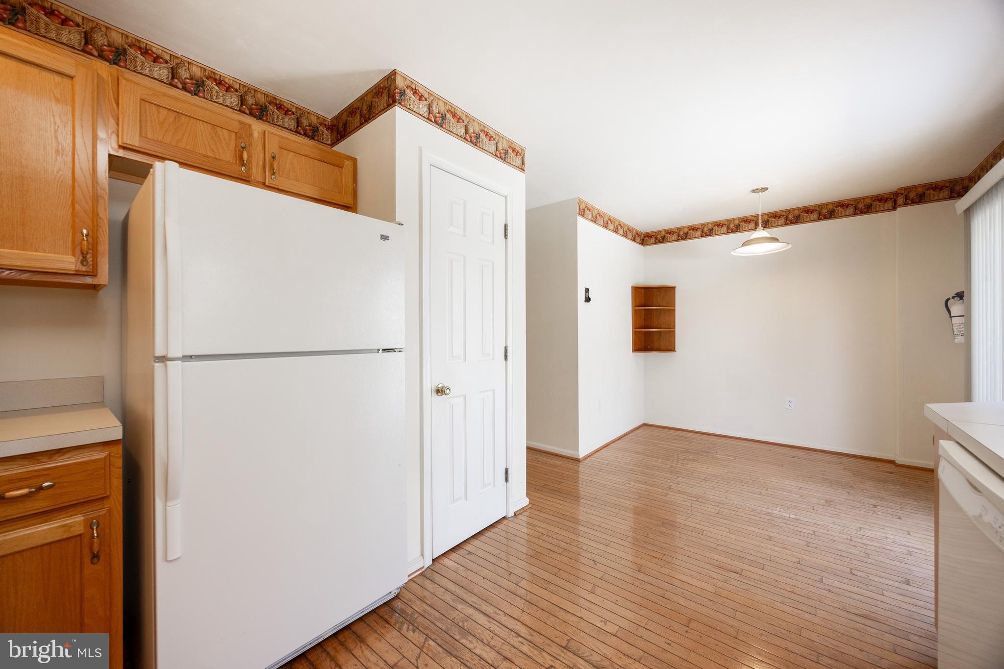 222 Springvalley Way Aston, PA 19014 - Photo 14 of 45 a view of a refrigerator in kitchen and wooden floor