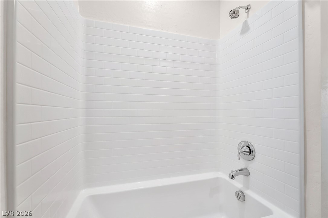 2555 Hampton Road, Unit 10108 Henderson, NV 89052 - Photo 18 of 23 Clean subway tile surrounds this integrated tub and shower combination.