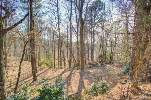 a view of outdoor space with wooden fence and trees